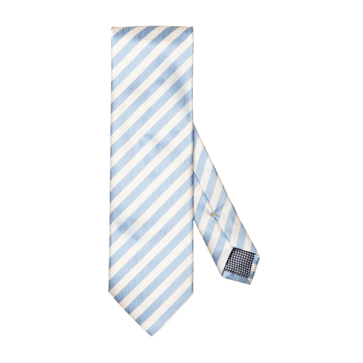 A sleek tie meticulously woven from 100% pure fabric, featuring a striking striped pattern and an elegant texture. The ideal complement to your spring office ensemble. 100% Silk.