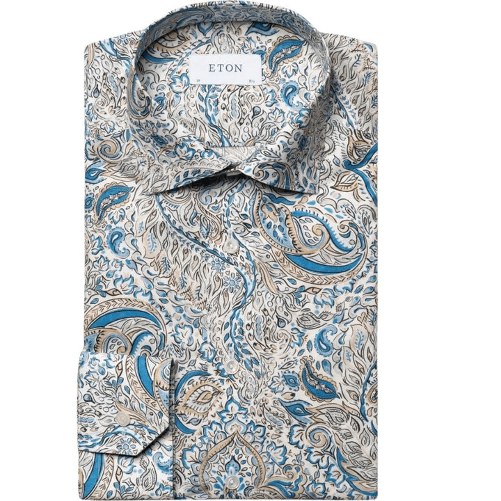 A refined dress shirt featuring an elegant paisley pattern, crafted from lightweight and luxurious fine twill fabric. Its smooth texture and graceful drape exude a professional and polished appearance. Adorned with exquisite mother-of-pearl buttons and precise 2mm stitching on both the collar and cuffs. Lightweight 100% cotton. Fine Twill weave. Mother-of-pearl buttons. Precise 2mm stitching on collar and cuffs.