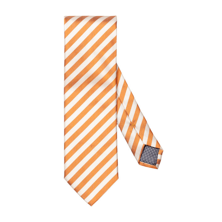 A sleek tie meticulously woven from 100% pure fabric, featuring a striking striped pattern and an elegant texture. The ideal complement to your spring office ensemble. 100% Silk. 