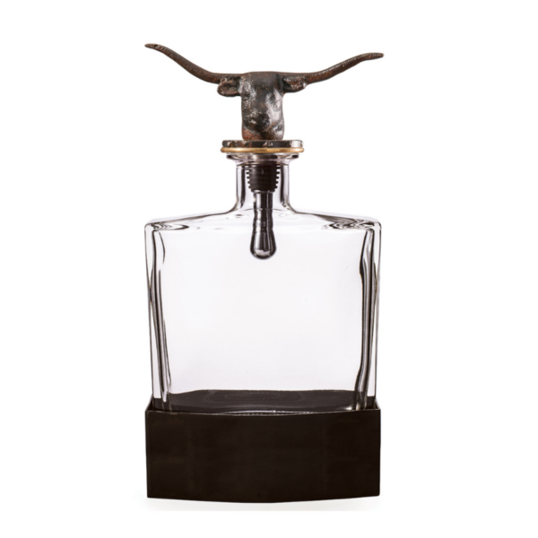 A clear, glass decanter with dual-purpose cork & screw, natural finish longhorn topper, and iron stand. Complete your bar cart with this rustic decanter. Dimensions: 6" x 3" x 10" Care instructions: Hand wash removable glass decanter. Soft dry cloth on an iron topper and stand.