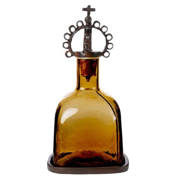 Mouth blown decanter, the color of toasted tobacco, resting in a wax cast tray, topped with a jubilant, pear-shaped corona de hierro . . . 