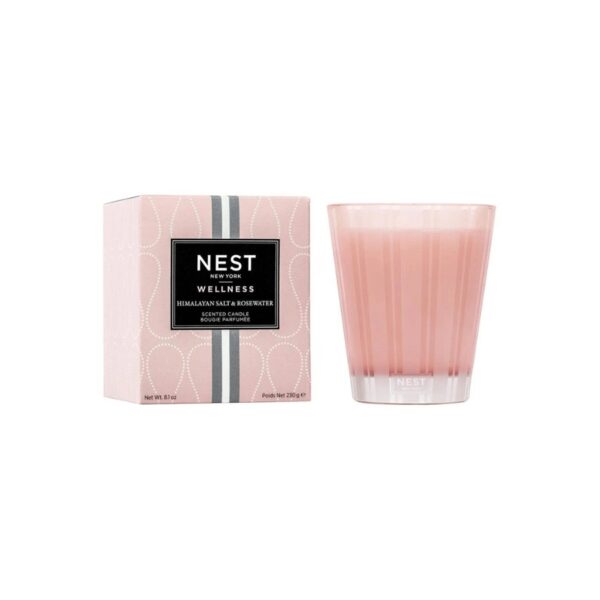 Ease your mind and soothe your spirit with this scented candle featuring notes of rosewater, geranium, salted amber, and white woods. This exquisitely fragranced candle is meticulously crafted with a proprietary premium wax formulated so the candle burns cleanly and evenly and infuses a room with exceptional scent. 8.1 oz | 230 g. Pink-tinted wax housed in a glass vessel of the same color etched with elegant, frosted stripes.