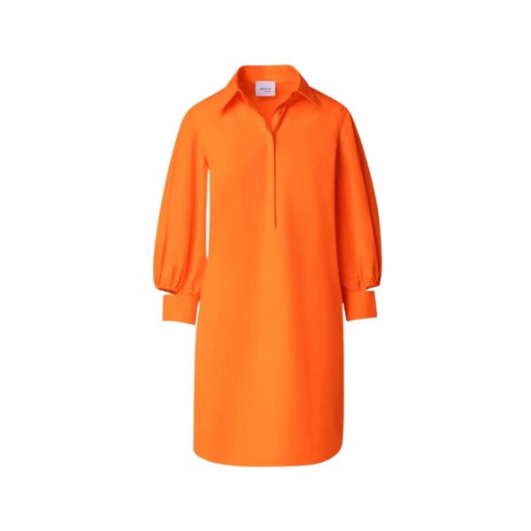 Akris punto dress features elastic cutout cuffs. Mandarin collar; concealed button placket. Long sleeves; button cuffs.  Side slits.  Hem hits around the knee. Shift silhouette. Cotton. Made in Romania.