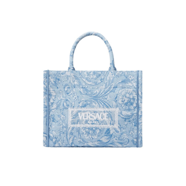 This small tote bag is crafted from jacquard Barocco canvas and features rigid top handles and a detachable crossbody strap that allows for multiple carry options. The spacious design is finished with a '90s Vintage Logo Versace embroidery. Barocco pattern. '90s Vintage Logo embroidery. Top handles. L11.2 x W5.1 x H8.7".
